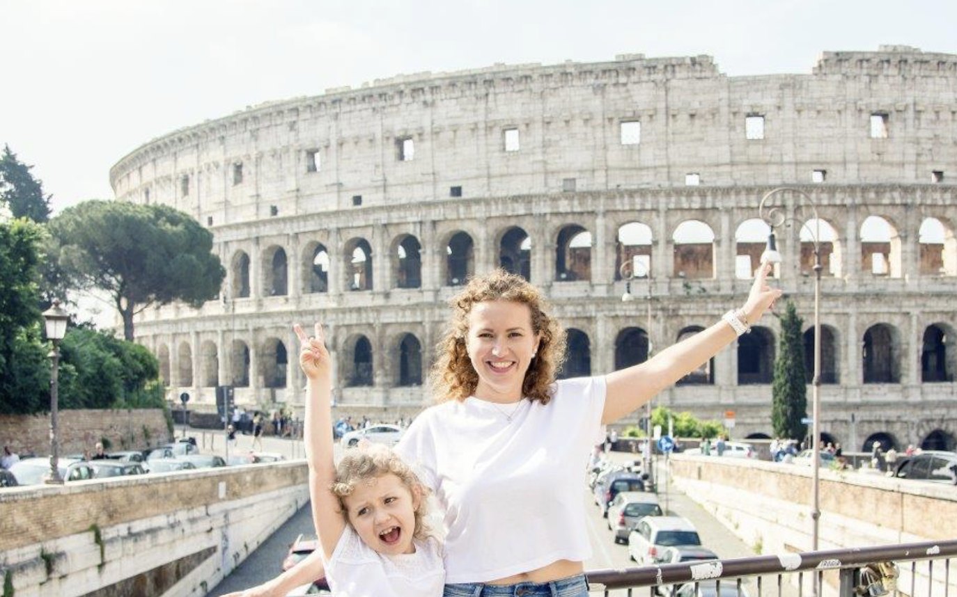 Mother and daughter cheering in front of the Colosseum