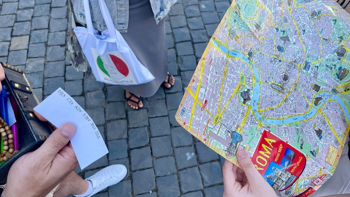 A map of Rome, envelopes and quest materials on the cobblestones