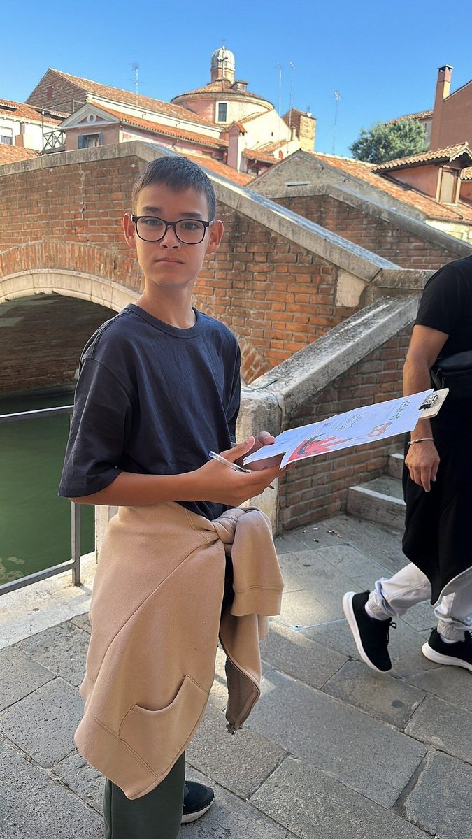 A teenager with the quest map by a bridge over the canal