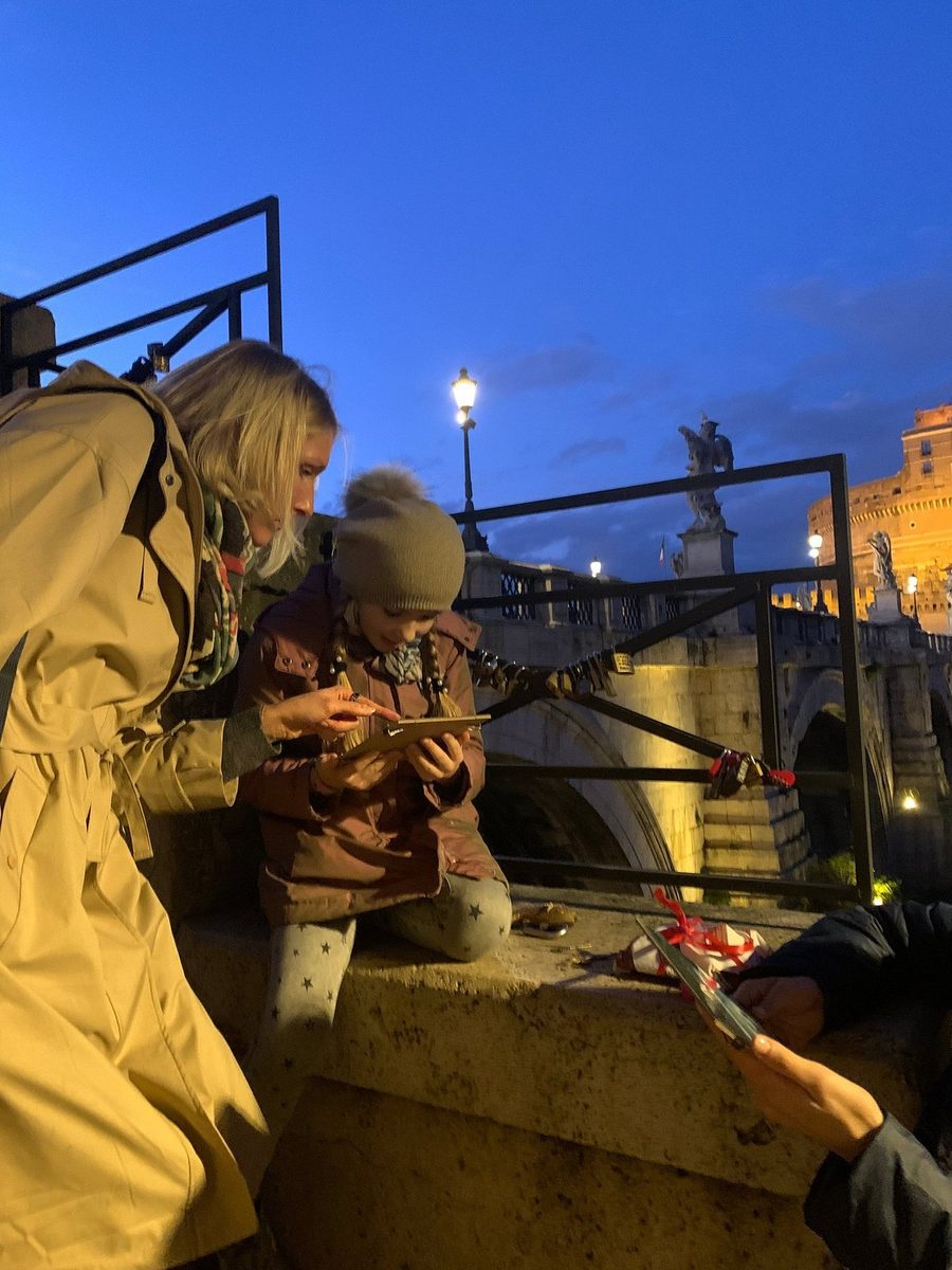 Children at the parapet of a bridge at dusk