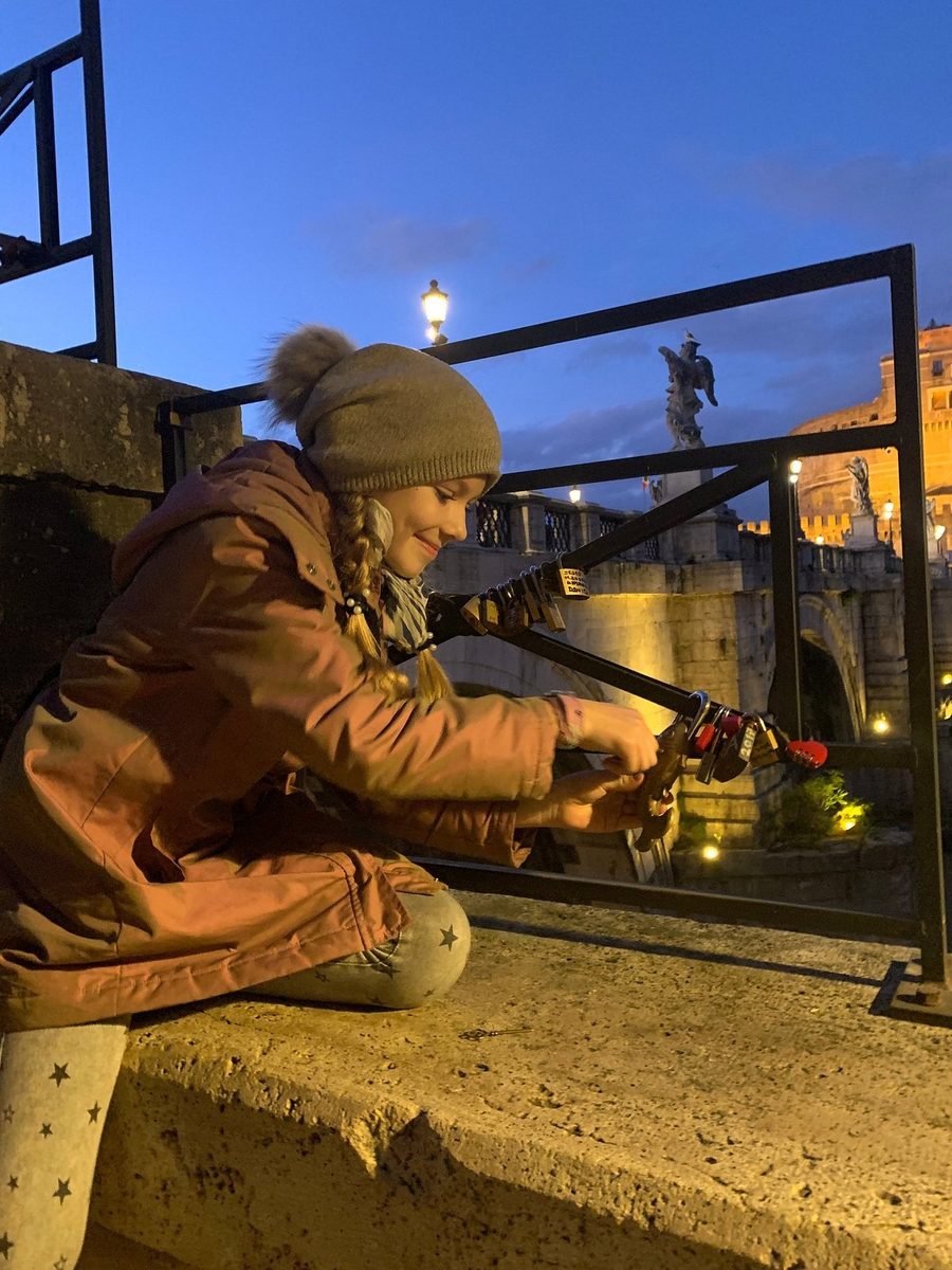 A child by an illuminated fountain in the evening