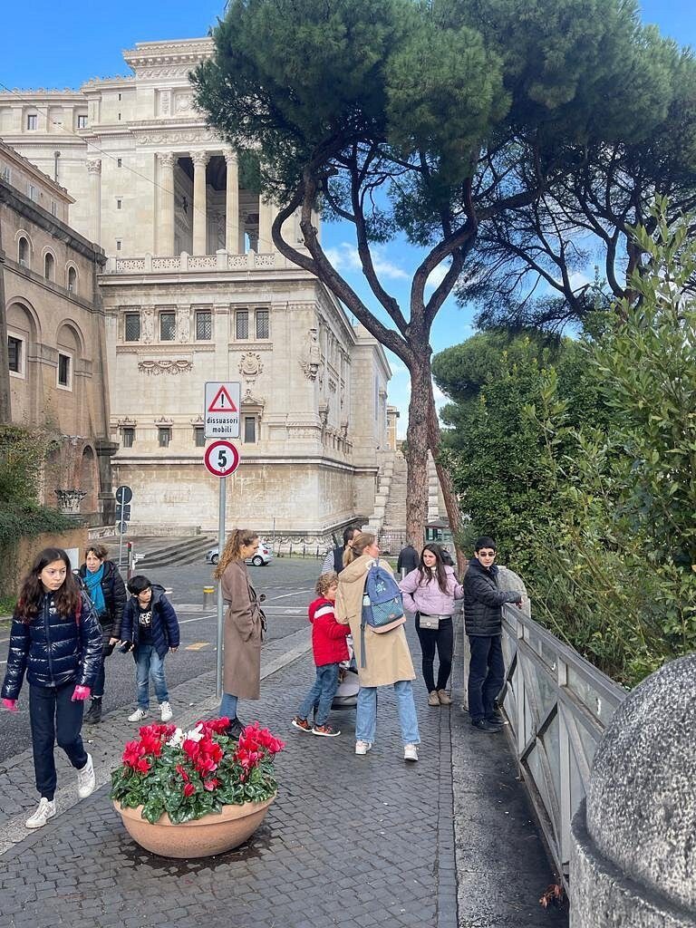 A walkway by the Vittoriano, flowers on the parapet