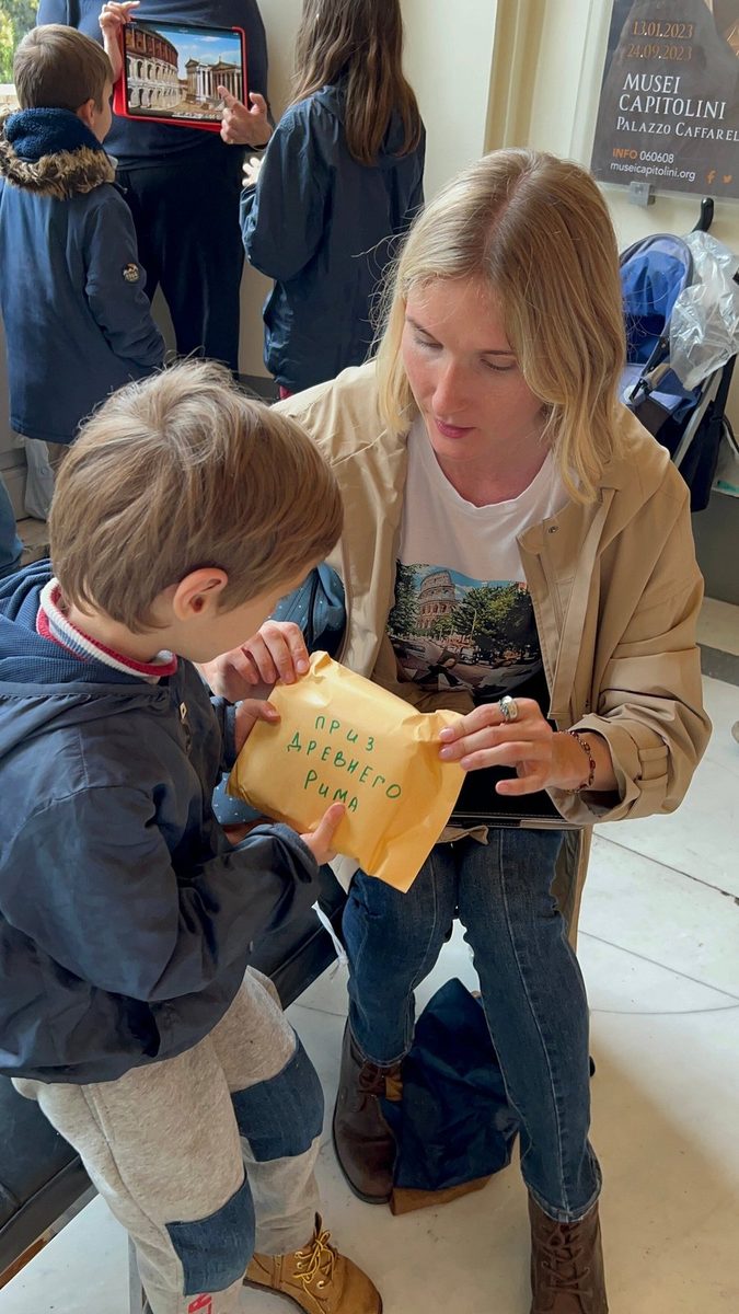 A boy opens the envelope with a quest task