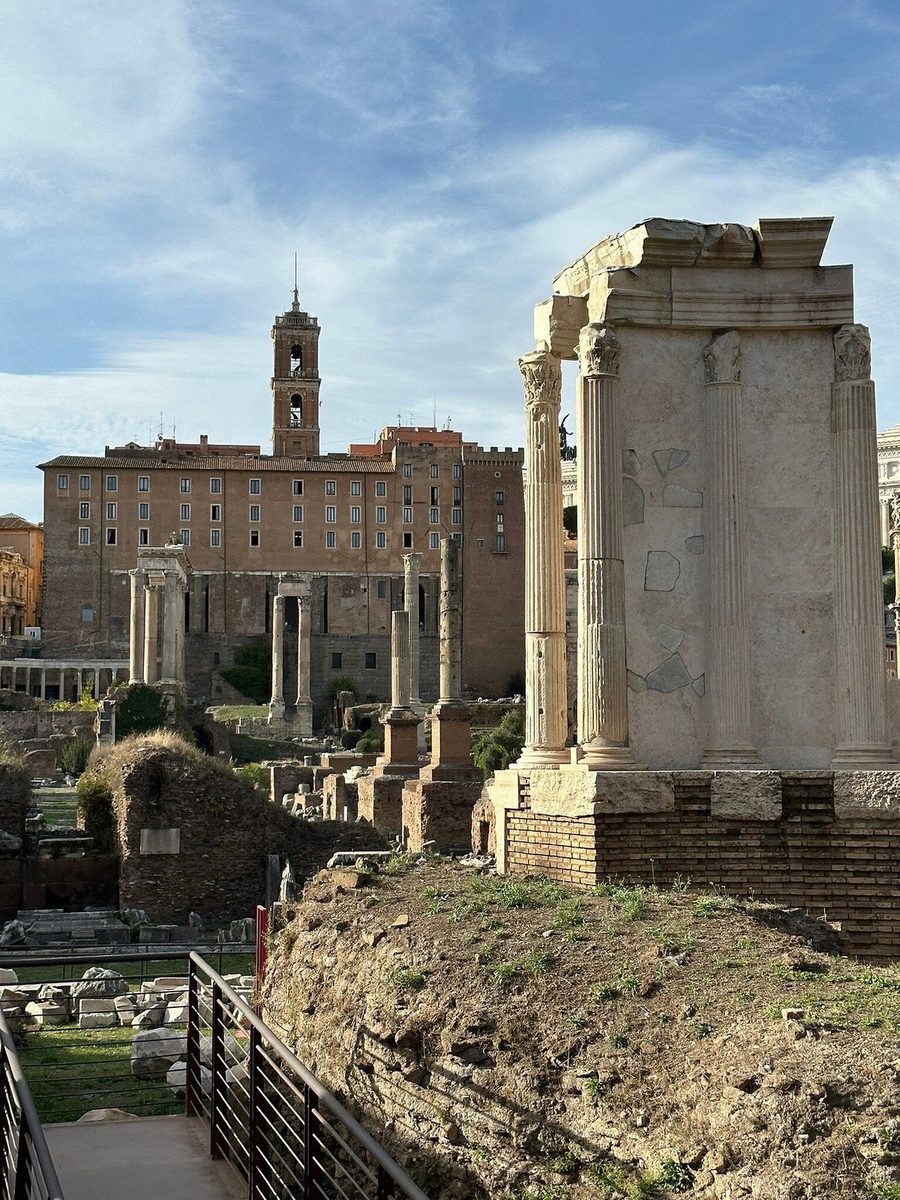 The columns of the Roman Forum, the Vittoriano in the distance
