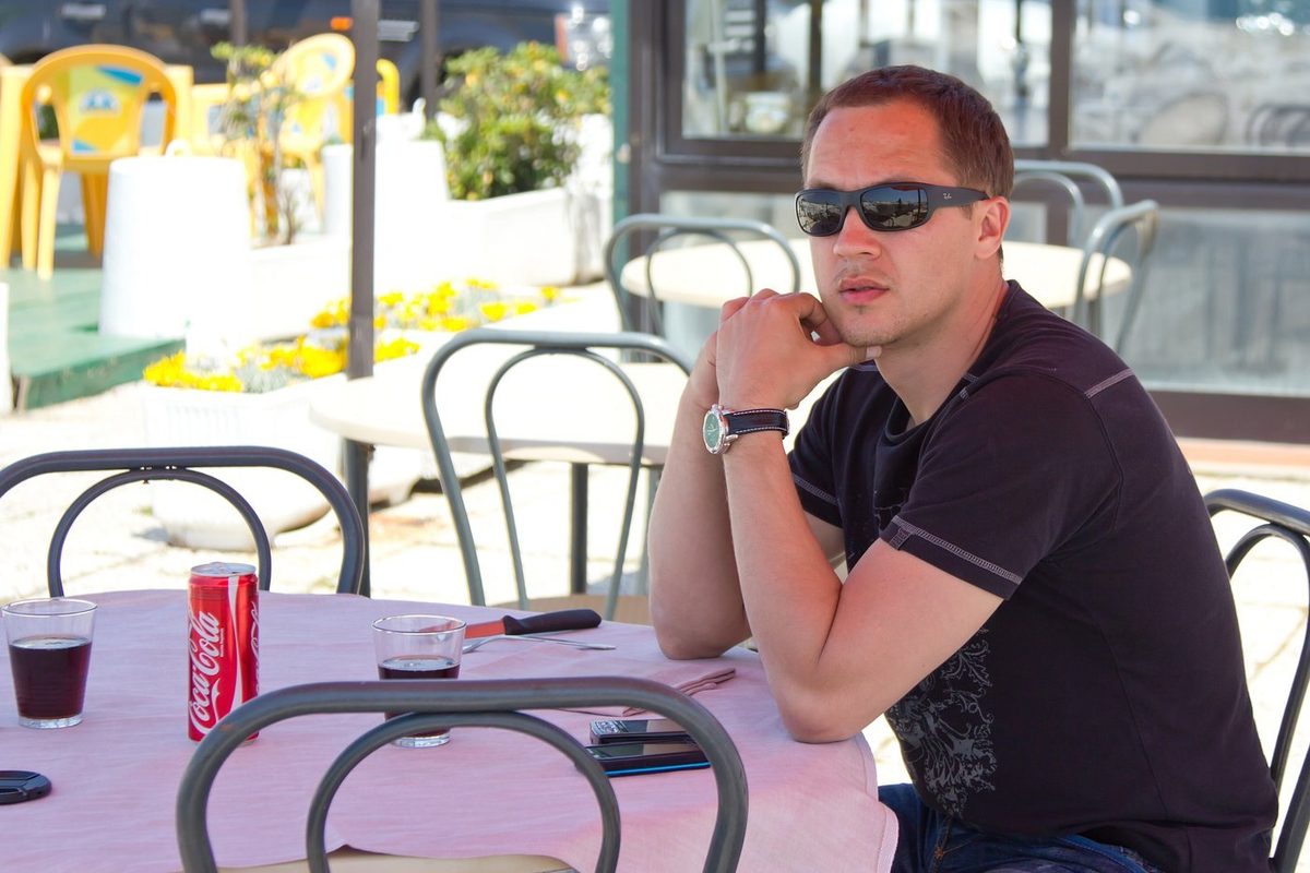 A guest at a street cafe table