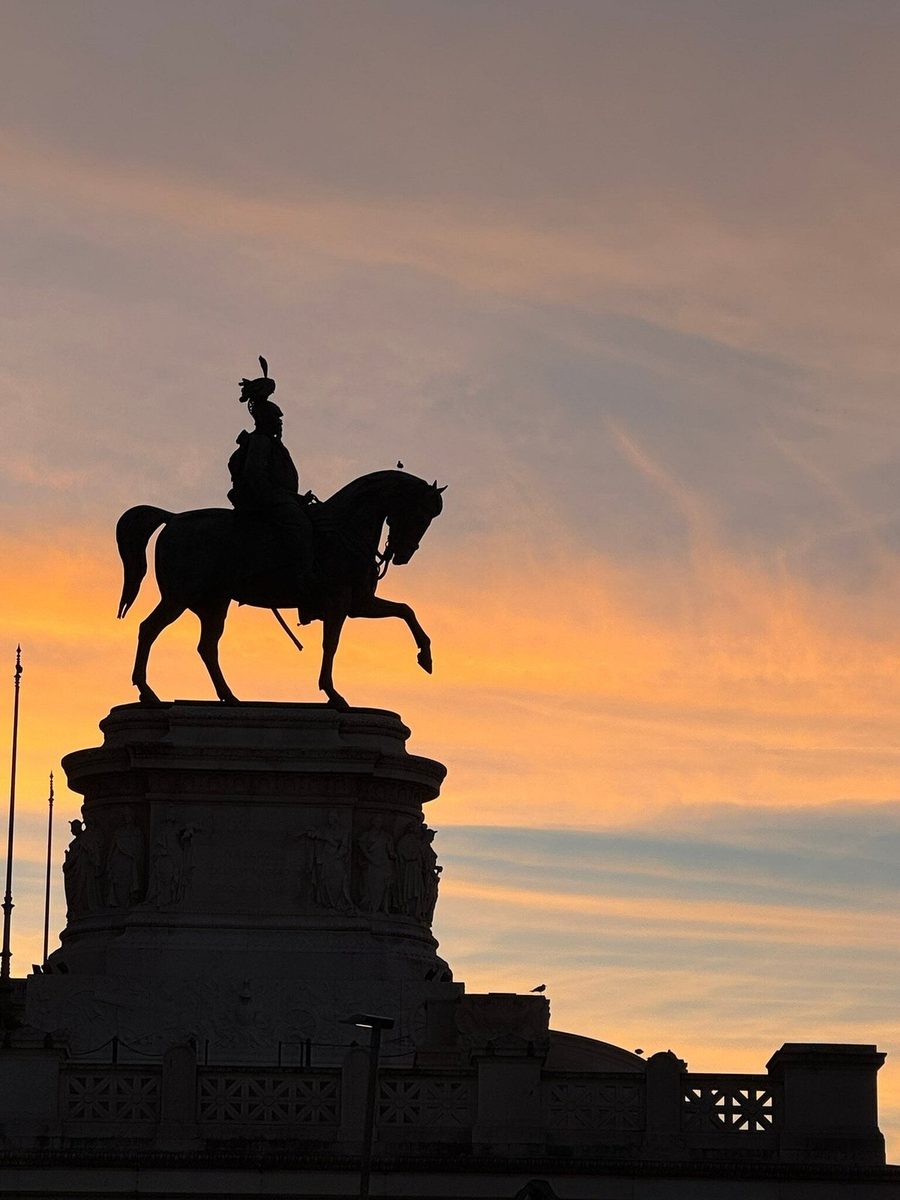 The silhouette of the equestrian statue on the Vittoriano at sunset